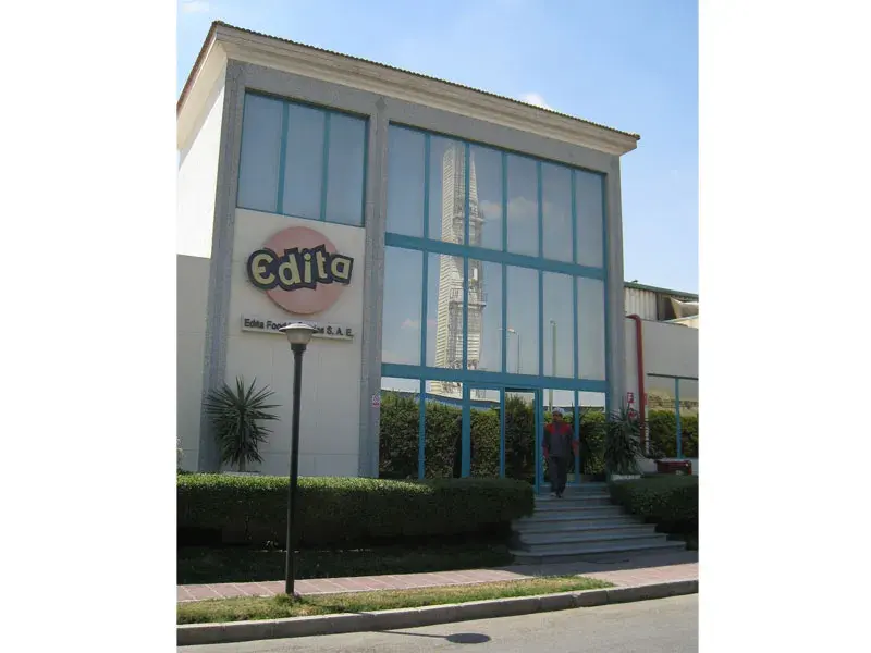 Exterior photograph of the Edita factory building in Beni Suef with its branded glazed entrance bay