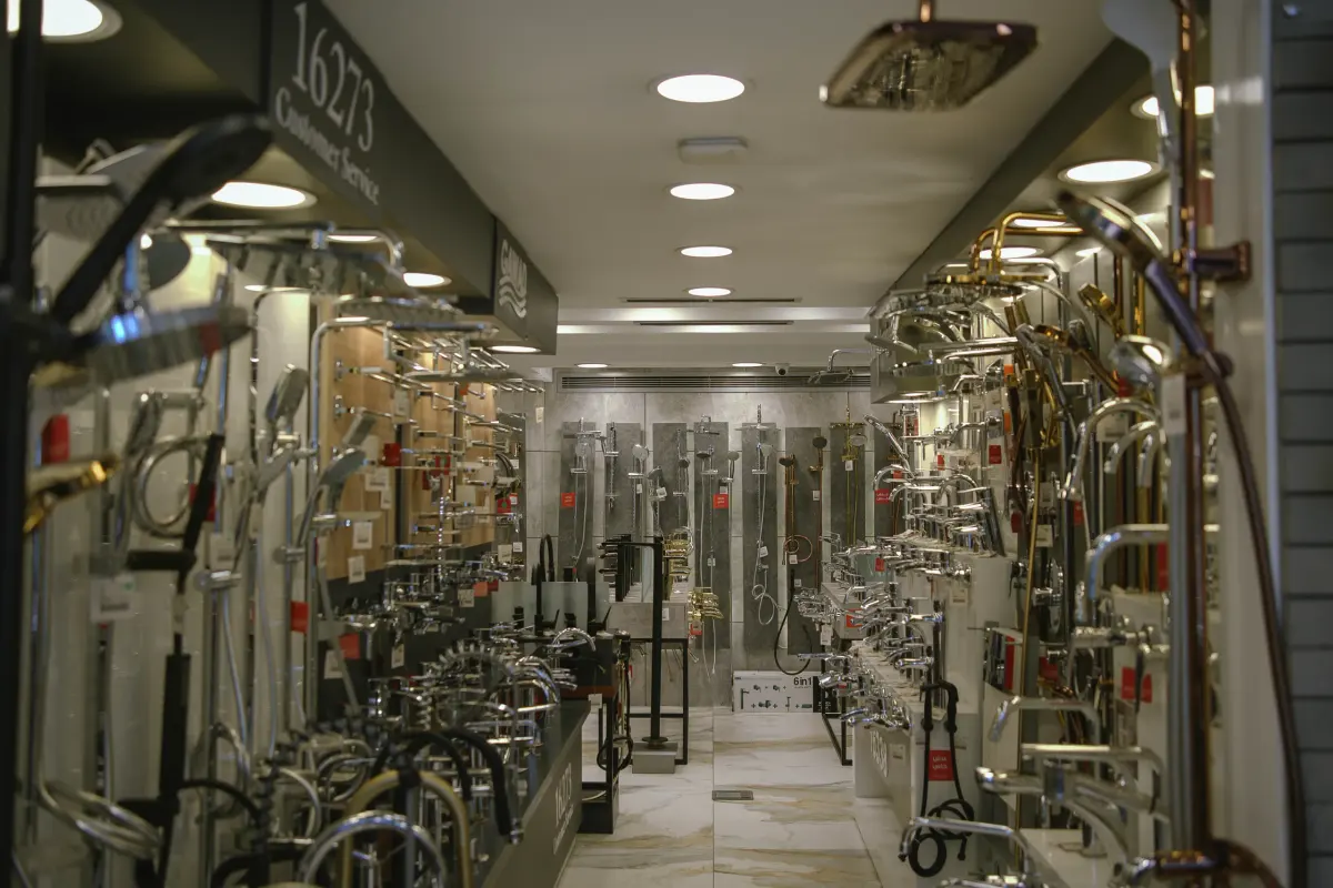 Interior photograph of the Mazloum Dokki showroom showing a sanitaryware display aisle under recessed ceiling lighting